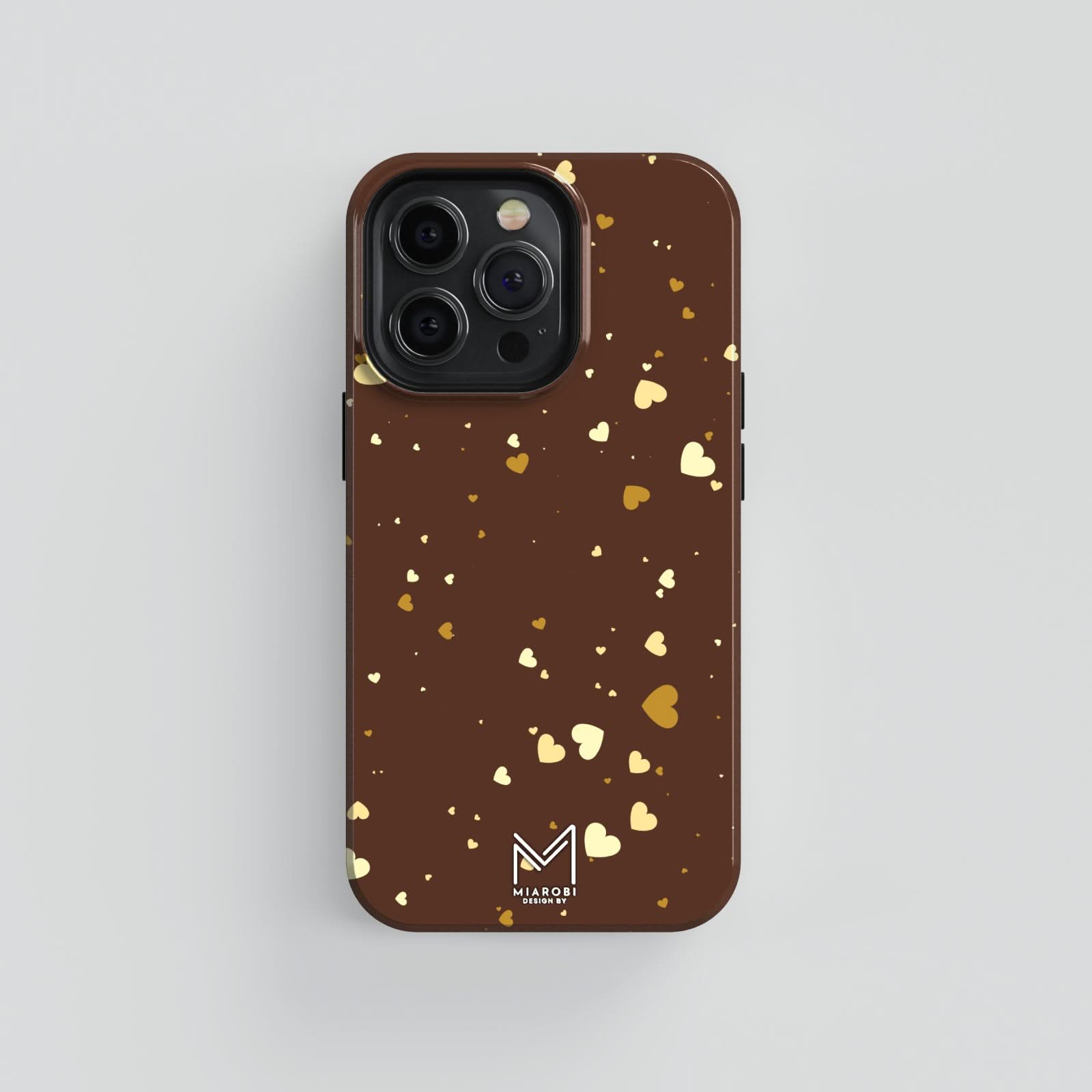 A brown aesthetic phone case with a scattered pattern of golden and light brown hearts.