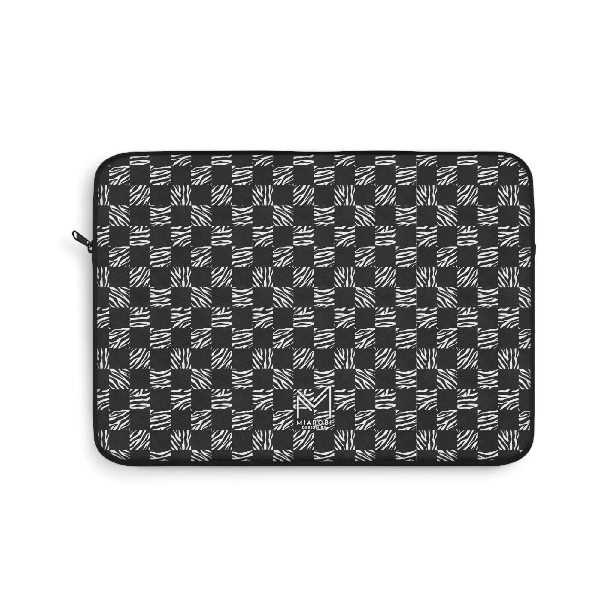 Checkered black and white 13" padded laptop sleeve on a marble desk with a MacBook