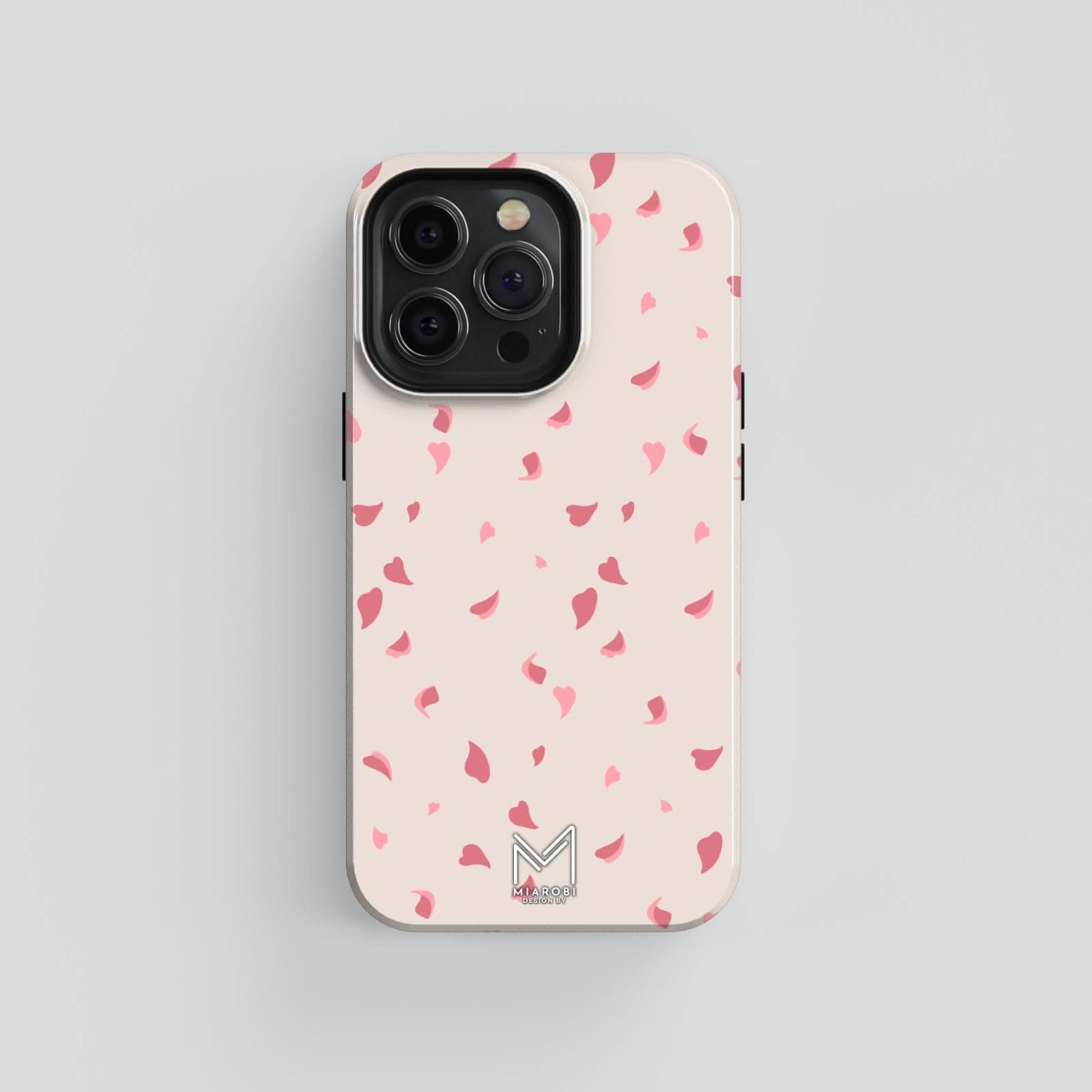 Latte beige phone case with scattered coral pink cherry blossom petals, showcasing a minimalist and elegant design.